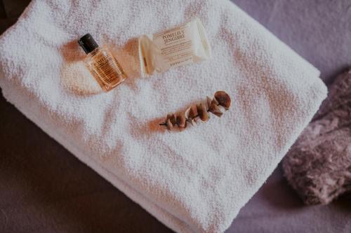 a white towel with a bottle of soap and a nail polish at Glamping y cabañas en Neusa Cundinamarca in La Esperanza