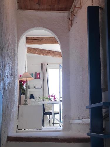 an archway in a room with a table and a window at Fisherman's View in Bages