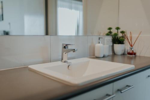 a white sink in a kitchen with a counter at Beach House at SeaScapes.. in Mandurah