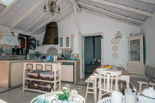 a kitchen with a table and chairs in a room at Casa Leandra con jacuzzi in Adeje