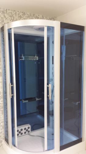 a glass door of a shower in a bathroom at Vrissaki Beach Hotel in Protaras