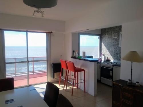 a kitchen with a view of the ocean at Departamento frente al mar in Santa Teresita