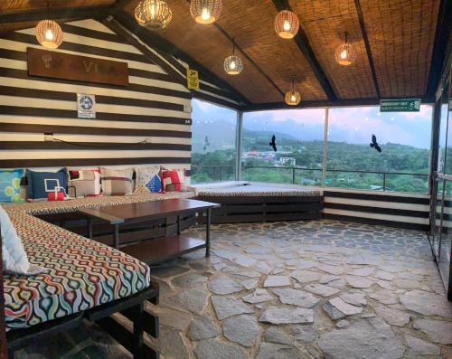 a room with two benches and a large window at Cabinas Vista Al Golfo in Monteverde Costa Rica