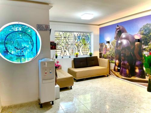 a living room with a couch and a window at Hotel Eterna Primavera in Medellín