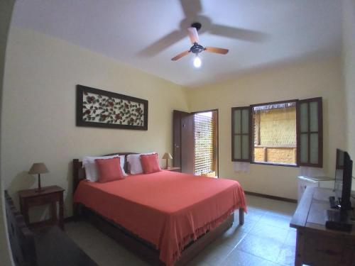a bedroom with a bed and a ceiling fan at Pousada da Terra Paraty in Paraty