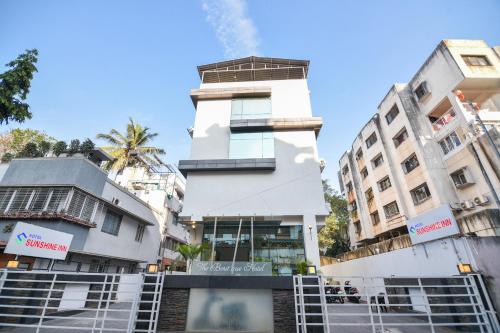 a building in the middle of some buildings at Hotel O Sunshine Inn Near Pune Railway Station in Pune