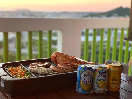 a tray of food and two cans of beer at Japanestジャパネスト in Tomigusuku