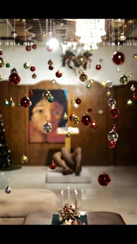 a room with christmas ornaments hanging from a wall at Raintree Boutique Villa & Gallery in Yogyakarta