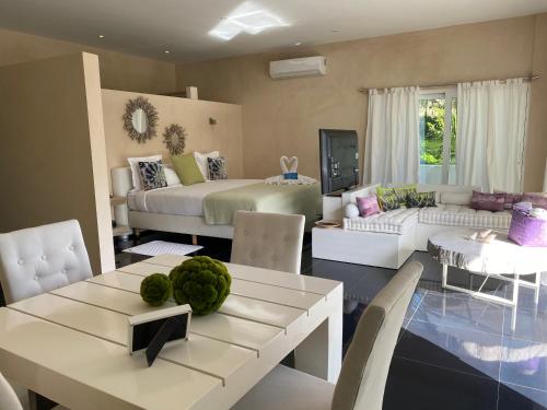 a living room with a bed and a dining room at CASA-22 Luxury Boutique Hotel in Sosúa
