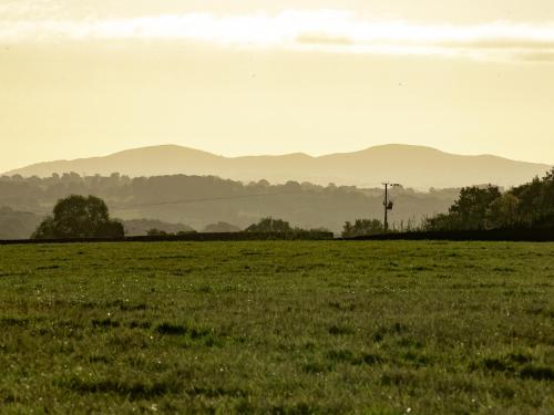 a field of grass with mountains in the distance at Frith Green in Bromyard