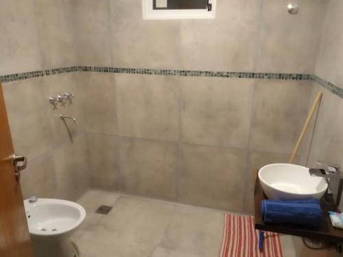 y baño con lavabo y aseo. en SIMION en Villa Carlos Paz