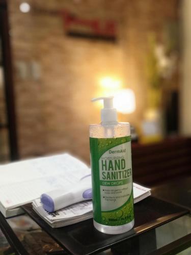 a bottle of hand sanitizer sitting on a table at Davao Hub Bed and Breakfast in Davao City