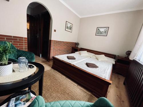 a bedroom with a bed and a table in it at Pension Silvie in Vlašim