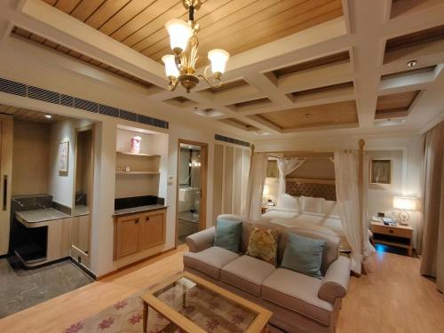 a living room with a couch and a kitchen at Welcomhotel by ITC Hotels, Tavleen, Chail in Chail