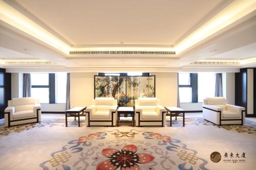 a large room with chairs and a table and a rug at Beijing Guangdong Hotel in Beijing