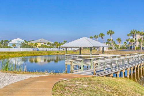 a wooden boardwalk next to a lake with a gazebo at Grand Caribbean Perdido Key 211 EAST in Pensacola