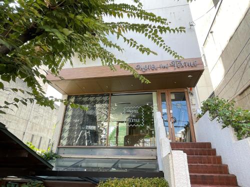 a store front of a building with a sign on it at hotel the textile in Gifu