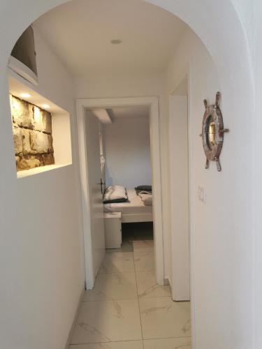 a hallway with a room with a bed in it at APARTMA KANTINA in Ankaran
