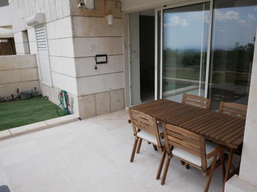 a wooden table and two chairs on a patio at Shoresh mountain in Shoresh