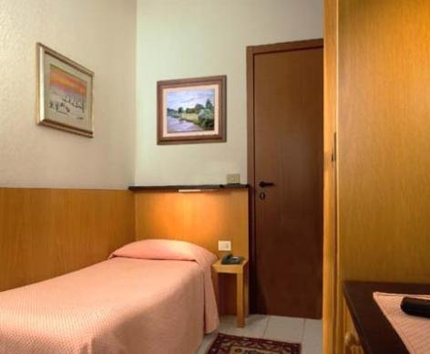 a bedroom with two beds and a door to a room at Giardino Hotel in Milan