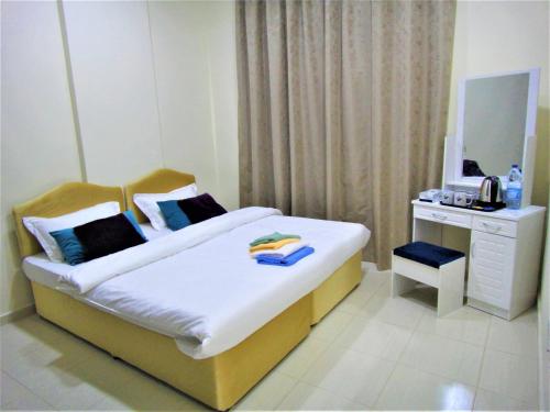 מיטה או מיטות בחדר ב-Abu Hail Star Residence - Home Stay