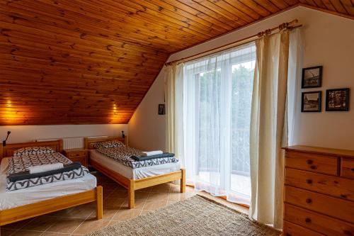 En eller flere senger på et rom på Villa Szalamandra - a Tisztás