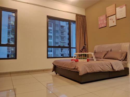a bedroom with a bed in a room with windows at #6 Summer Studio - One South in Seri Kembangan