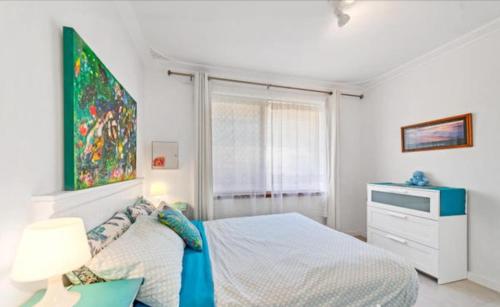 a bedroom with a bed and a painting on the wall at Island Villas Accommodation Unit 4-108 Arcadia Drive Shoalwater in Safety Bay