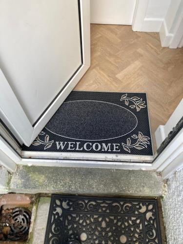 a welcome mat on the floor of a house at Lazy Days Cottage in Barrowford