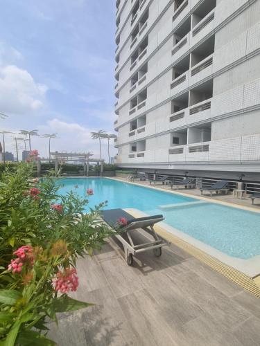 a swimming pool next to a tall building at BU Place Hotel in Bangkok