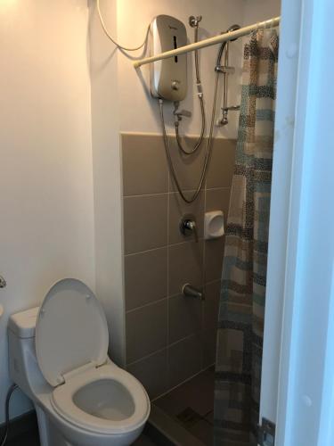 a bathroom with a toilet and a shower at Aspira Studio for daily monthly yearly guests preferably those with new job assignments in Cagayan de Oro CIty in Cagayan de Oro