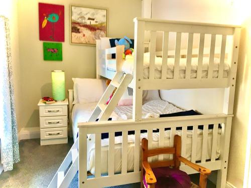 a childs bedroom with a white bunk bed at Ceim house, Restful rural home Gap of dunloe, Killarney in Derrylea