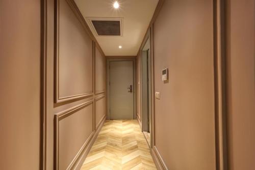 an empty corridor with a door and a hallway at Concept Nisantasi Hotels & Spa in Istanbul