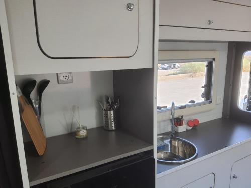 a kitchen with a sink and a counter top at Ein Gedi caravan by Dory caravan in Ein Gedi