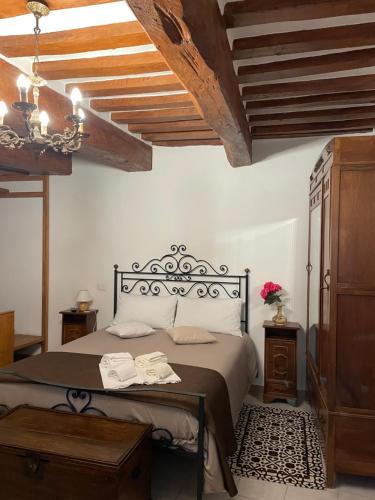a bedroom with a bed and a wooden ceiling at Affittacamere Mirella in Gubbio