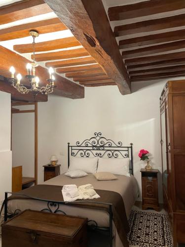 a bedroom with a bed with a wooden ceiling at Affittacamere Mirella in Gubbio