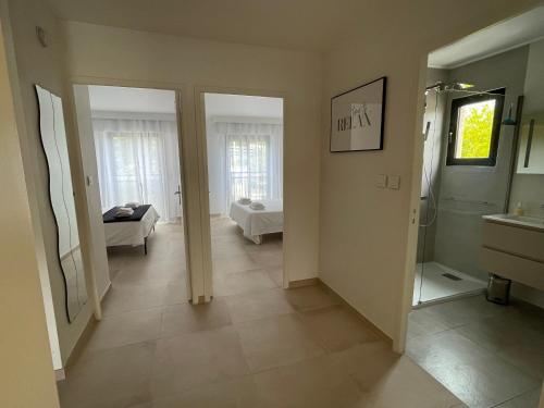 un couloir avec salle de bains et une chambre avec baignoire dans l'établissement Domaine D'Ahmosis, modern 2 bedrooms refurbished apartment, f3 moderne fraichement rénové, au Cannet