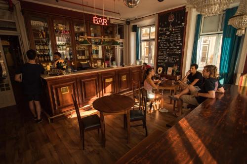 a group of people sitting at a bar at Home Lisbon Hostel in Lisbon