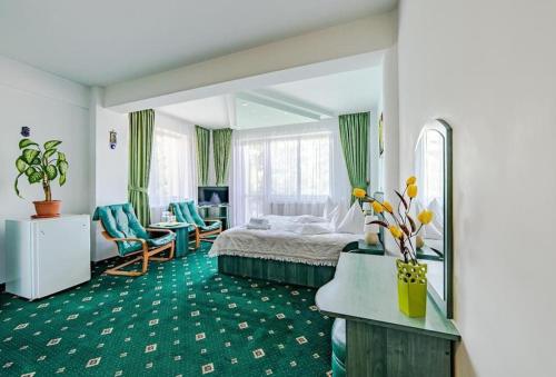 um quarto de hotel com uma cama e um espelho em Pensiunea turistica Andra em Predeal