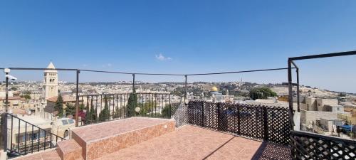 a balcony with a view of a city at New Citadel Hostel in Jerusalem