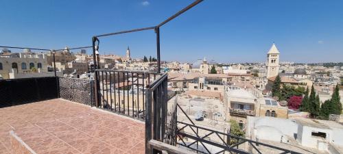 a view of a city from a balcony at New Citadel Hostel in Jerusalem