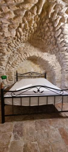 a bedroom with a bed in a stone wall at New Citadel Hostel in Jerusalem