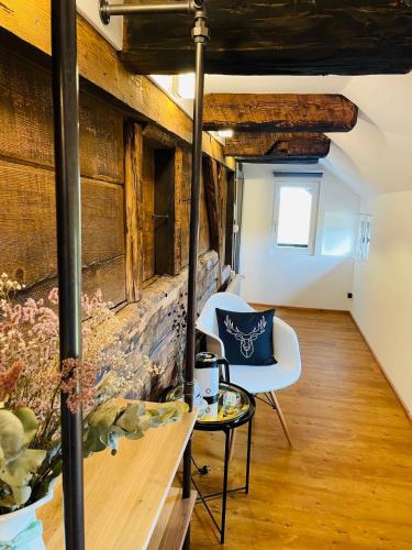 a room with a table and a chair and a brick wall at RotmeerHaus in Feldberg