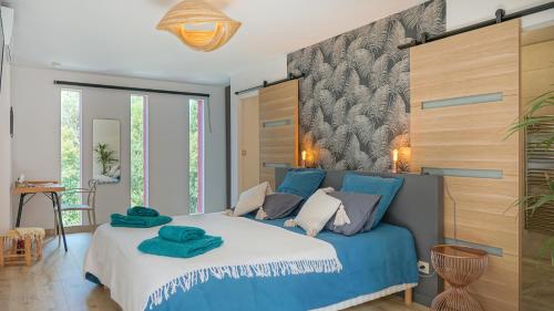 a bedroom with a blue and white bed in a room at VILLA MAGNOLIA in Montpellier