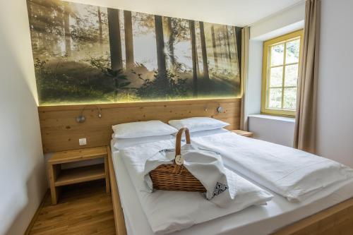 a bedroom with a bed with a basket on it at Boutique rooms Pri Rogovilcu in Solčava