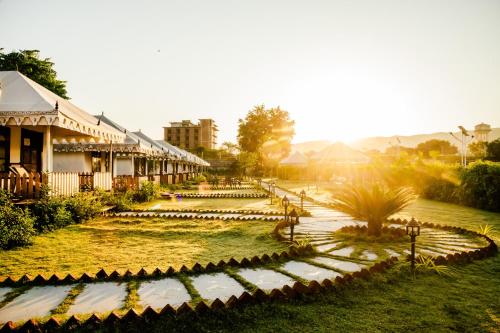 a garden in front of a building at Rawai Luxury Tents Pushkar in Pushkar