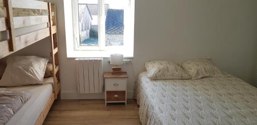 a small bedroom with a bed and a window at Gîte Lucian Mont-saint-michel in Moidrey