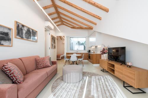 a living room with a couch and a tv at Lidador 116 Apartments in Vila do Conde