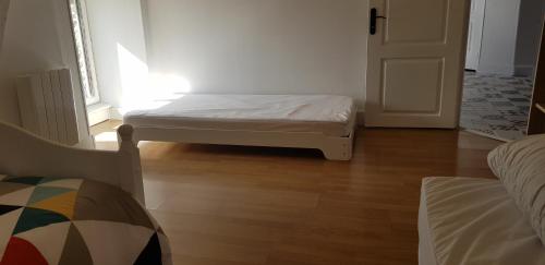 a small bedroom with a bed and a door at Gîte Lucian Mont-saint-michel in Moidrey