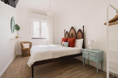 una camera da letto con un letto grande con cuscini rossi di Caíque - Apartamento com 3 Quartos na Zona Típica de Olhão, Algarve, Portugal a Olhão